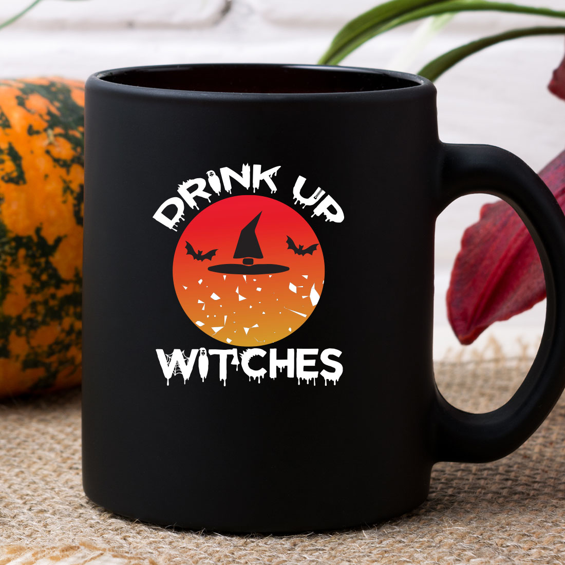 Black coffee mug with the words drink up witches on it.
