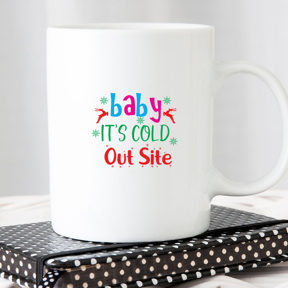 White coffee mug that says baby it's cold out site.