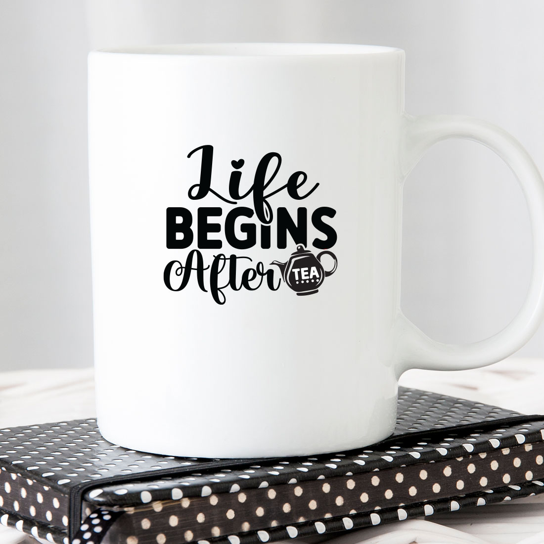 White coffee mug sitting on top of a book.