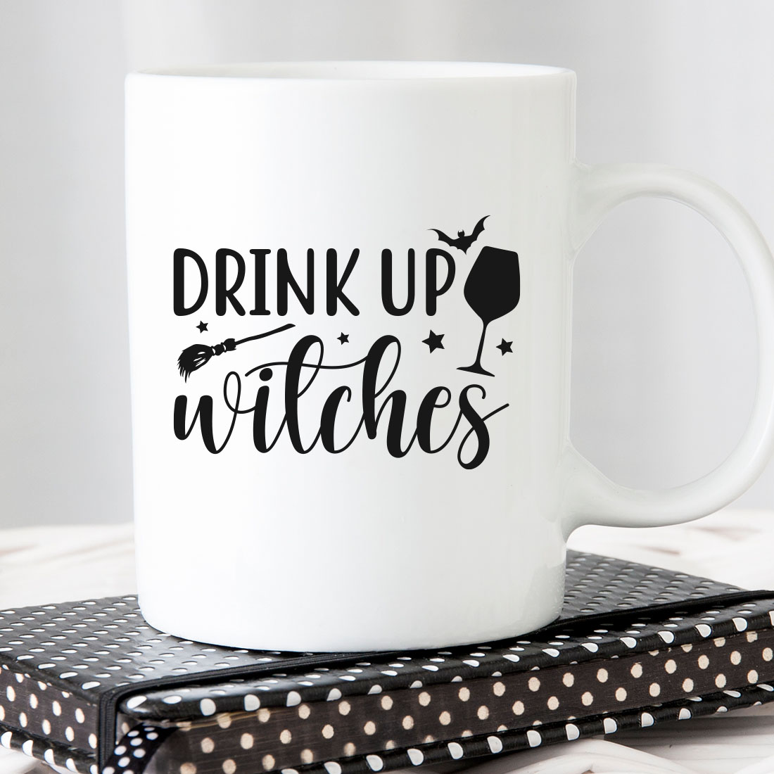 White coffee mug that says drink up witches.