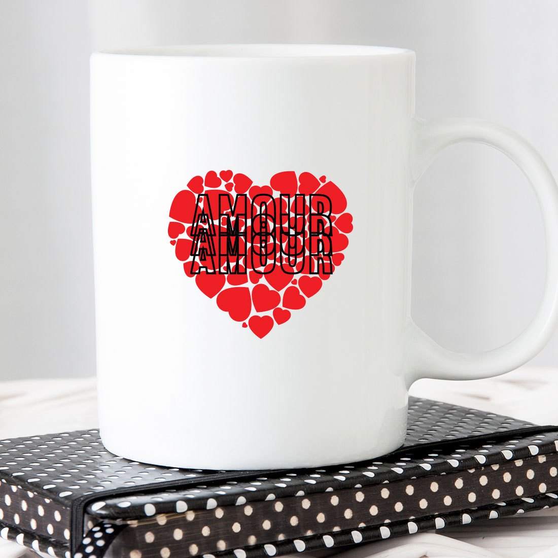 White coffee mug with a red heart on it.