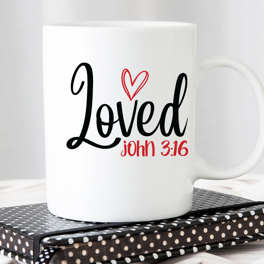 White coffee mug with the words loved on it.