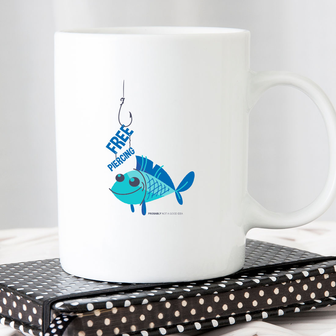 White coffee mug with a blue fish on it.