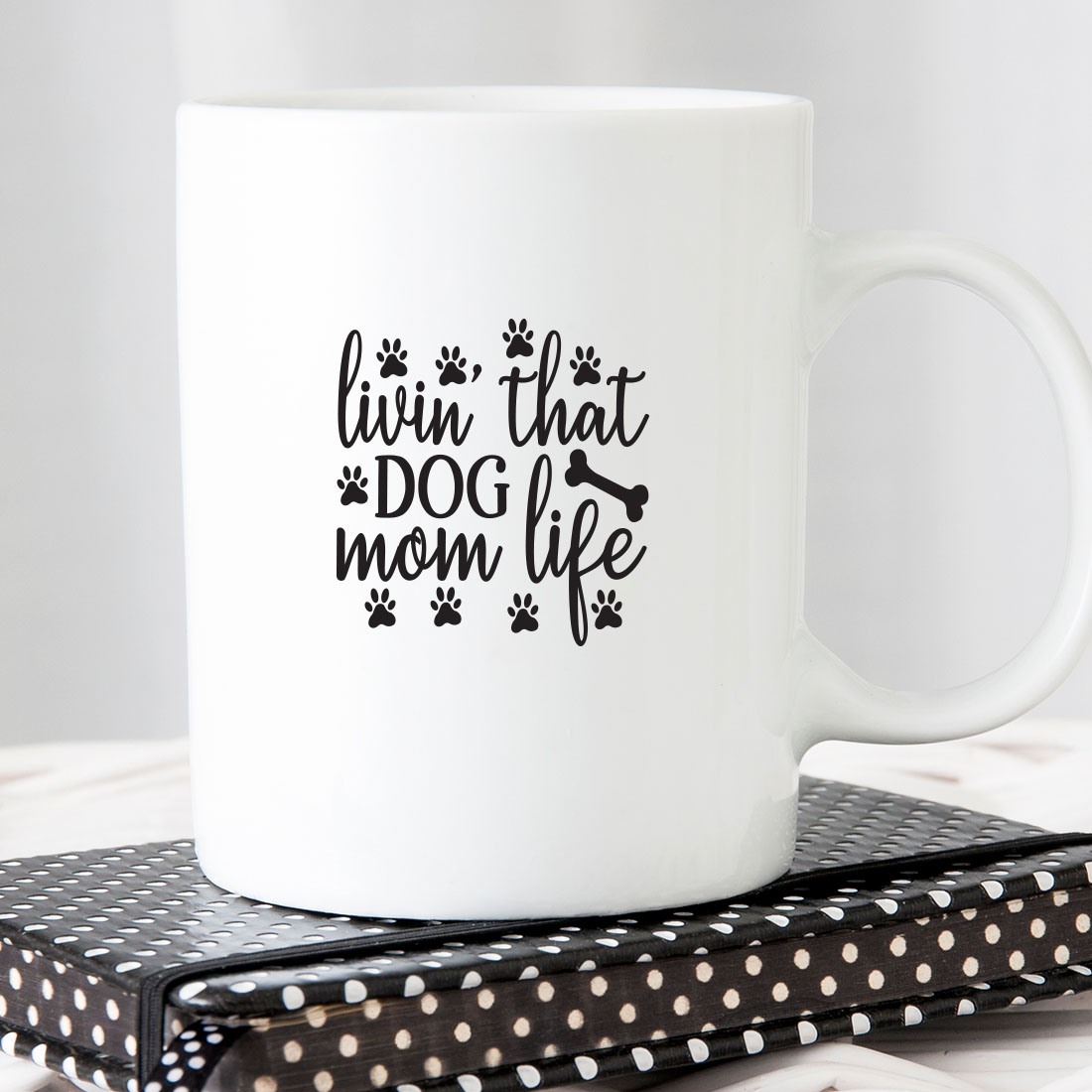 White coffee mug sitting on top of a book.