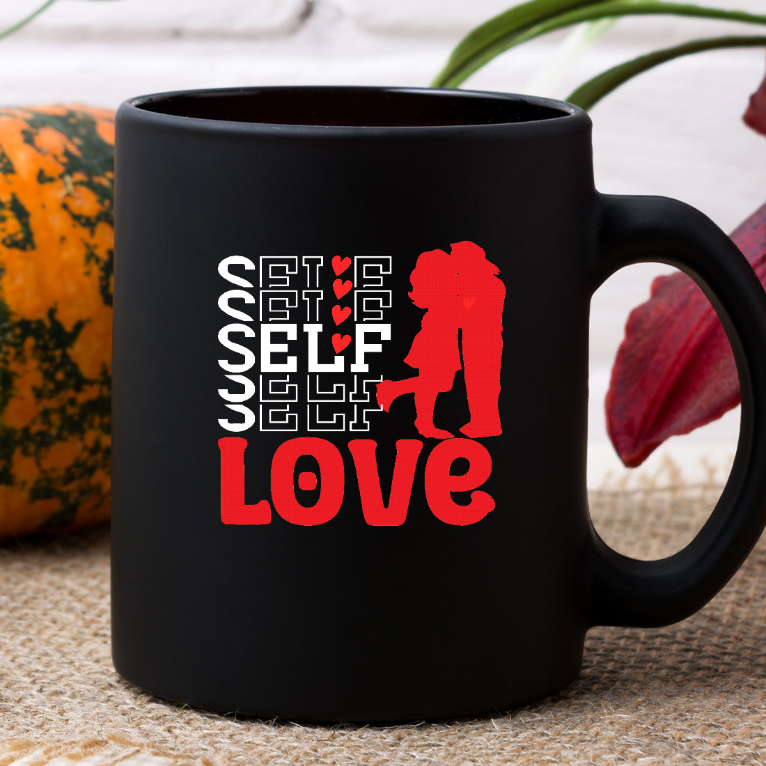 Black coffee mug with a red design on it.