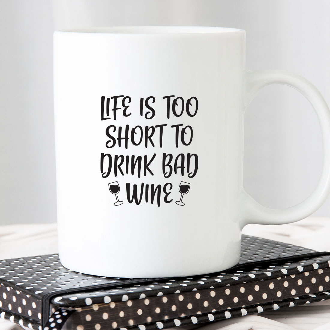 White coffee mug that says life is too short to drink bad wine.