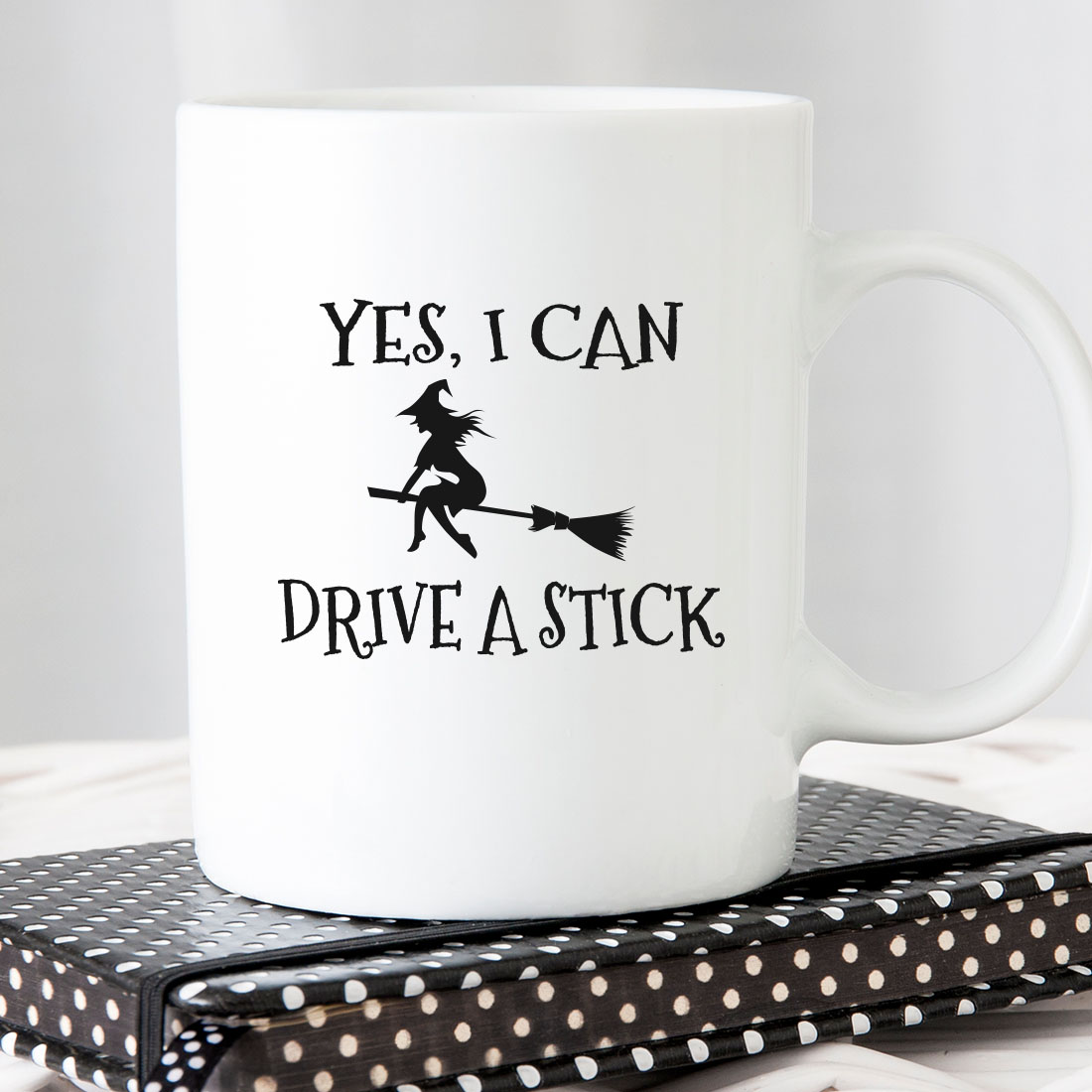 White coffee mug that says yes i can drive a stick.