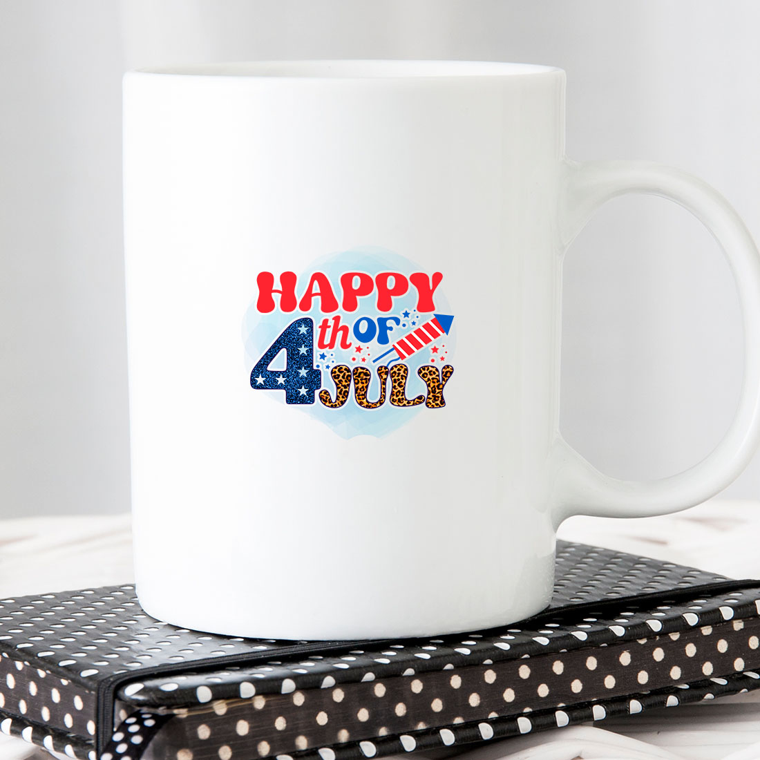 White coffee mug with the words happy fourth of july on it.