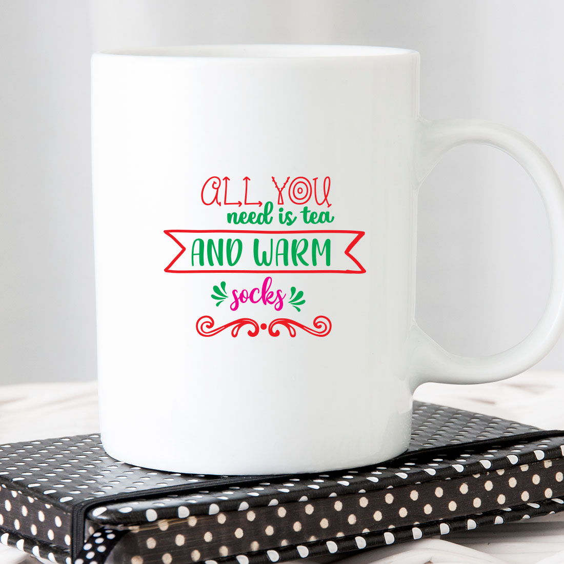 White coffee mug sitting on top of a book.