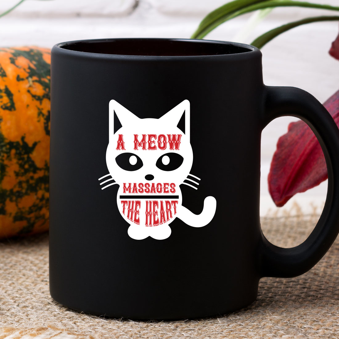 Black coffee mug with a white cat on it.