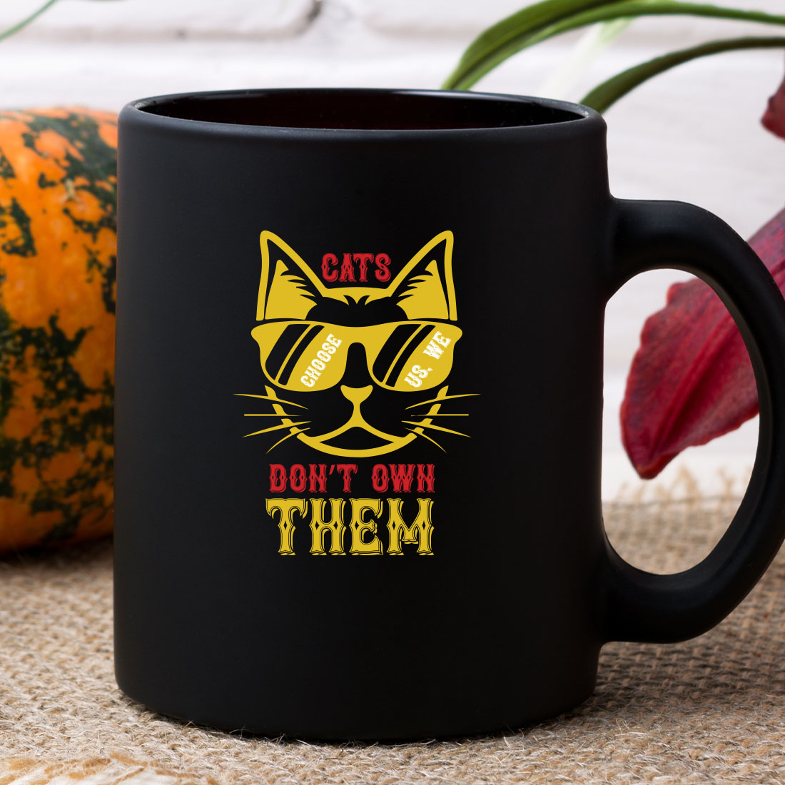 Black coffee mug with a cat's don't own them on it.