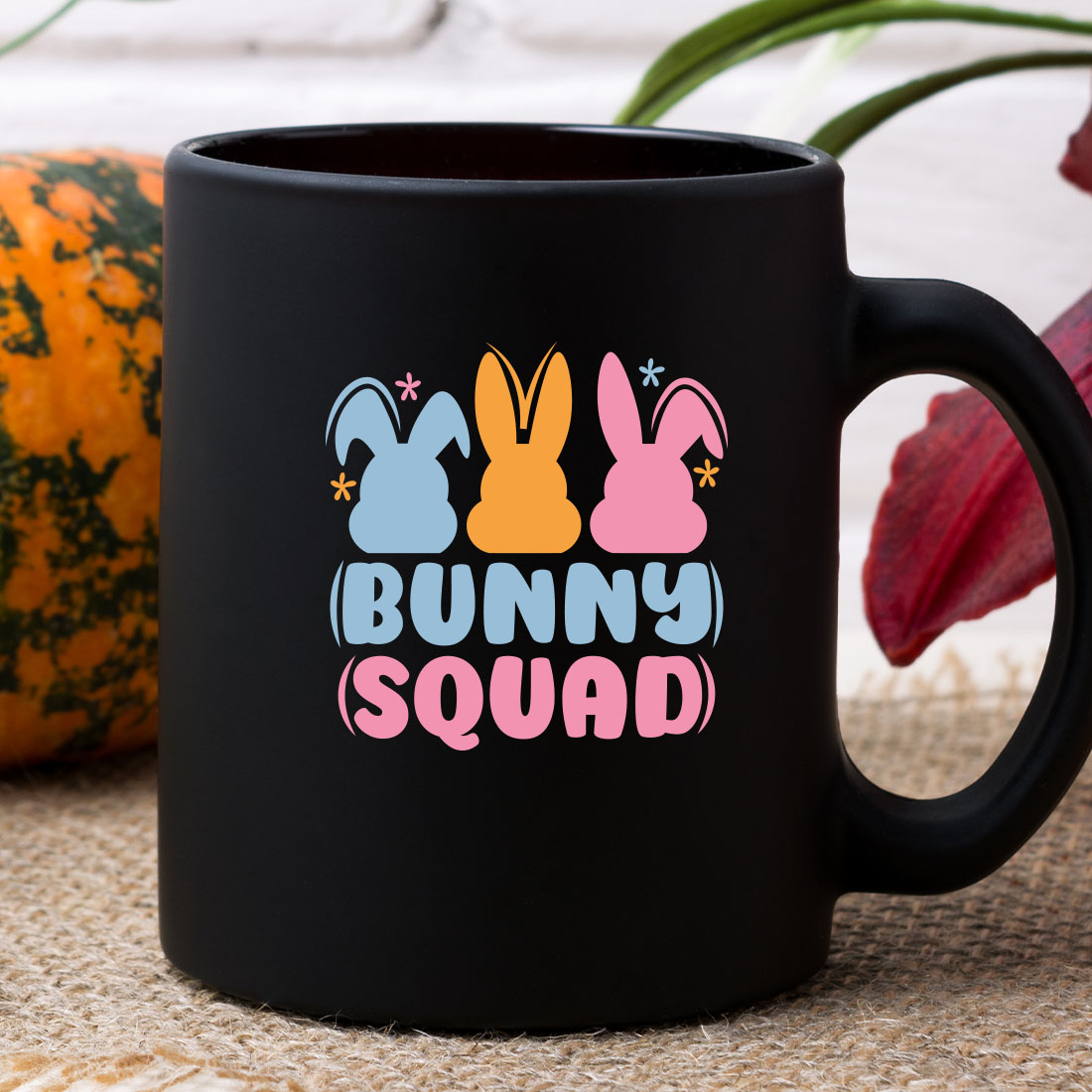 Black coffee mug with bunny squad on it.