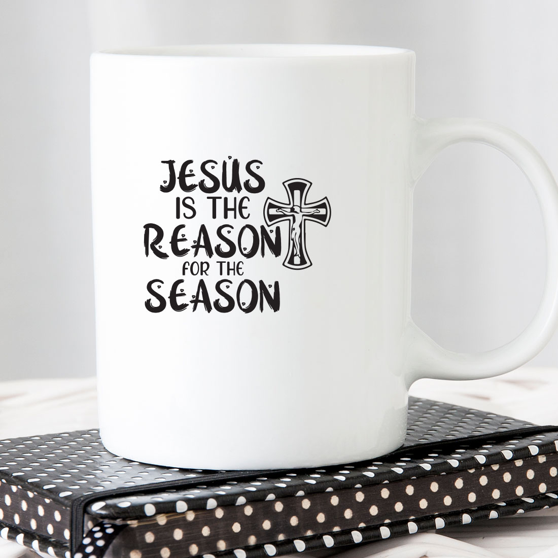 White coffee mug with the words jesus is the reason for the season on it.