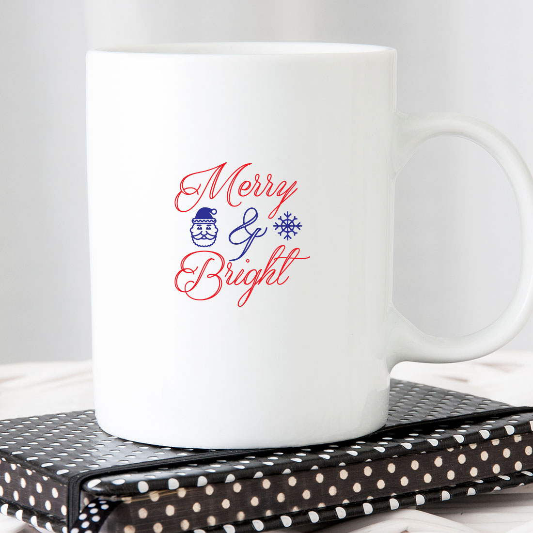 White coffee mug sitting on top of a book.