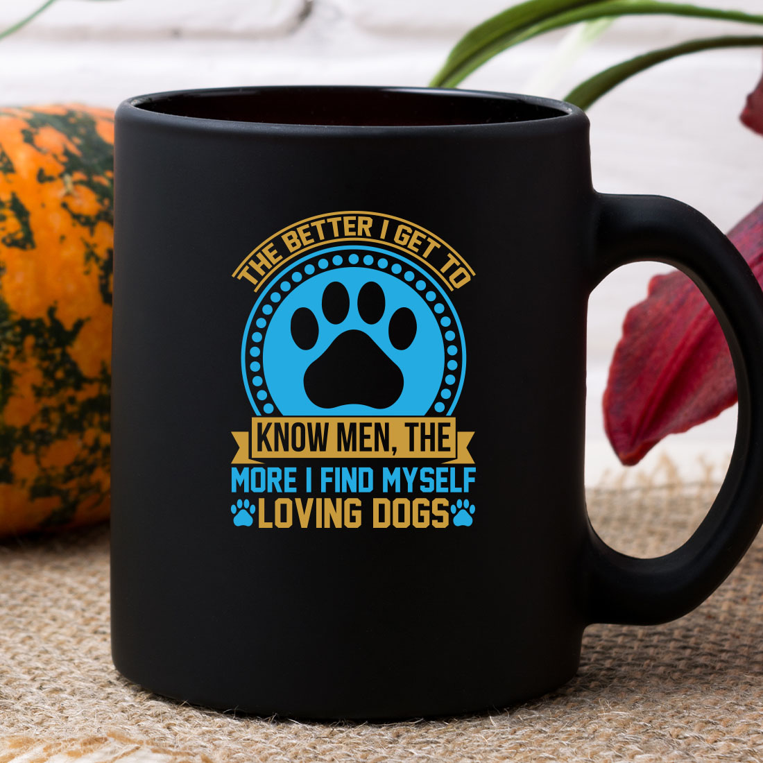 Black coffee mug with a dog's paw on it.