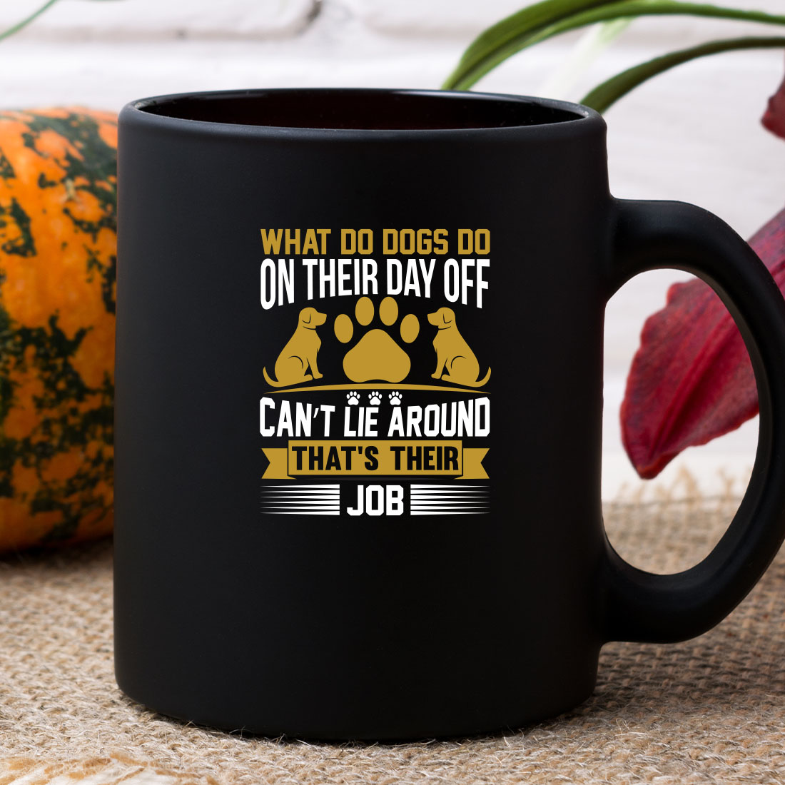 Black coffee mug sitting on top of a table.