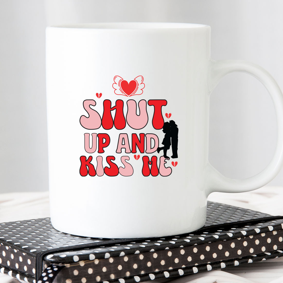 White coffee mug with the words shut up and kiss me on it.