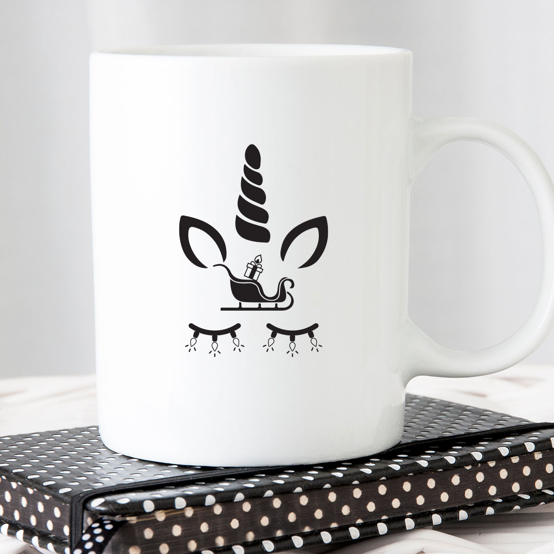 White coffee mug with a black unicorn on it.