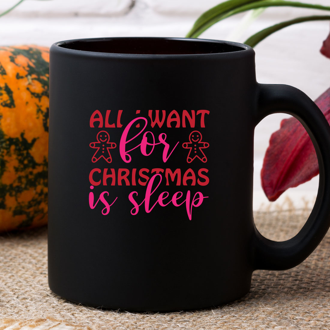 Black coffee mug with pink lettering on it.