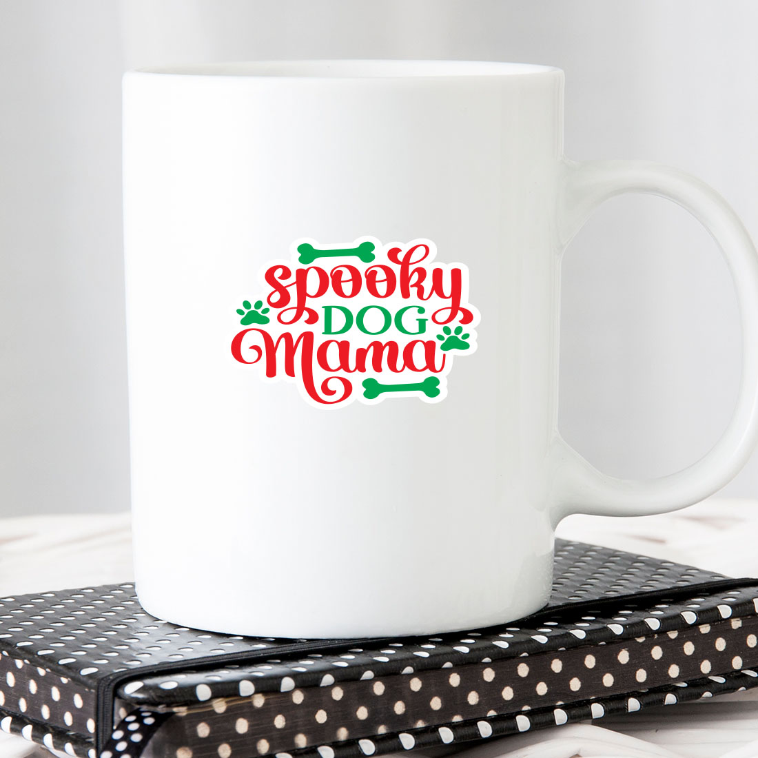 White coffee mug with the words spooky dog mama on it.