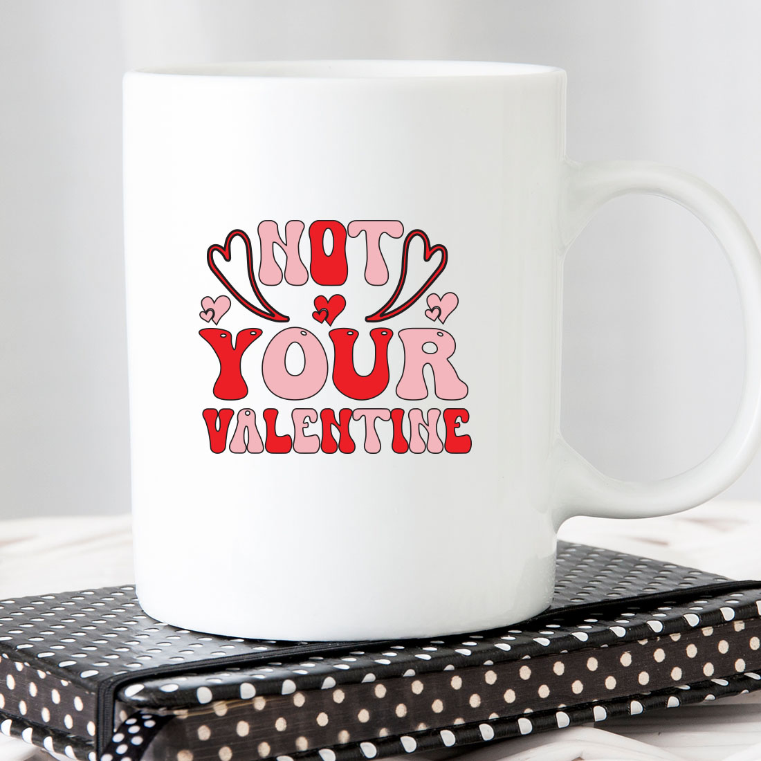 White coffee mug that says not your valentine.