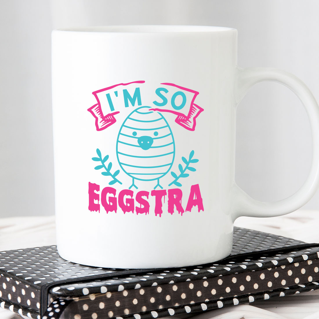 White coffee mug with the words i'm so eggstra on it.