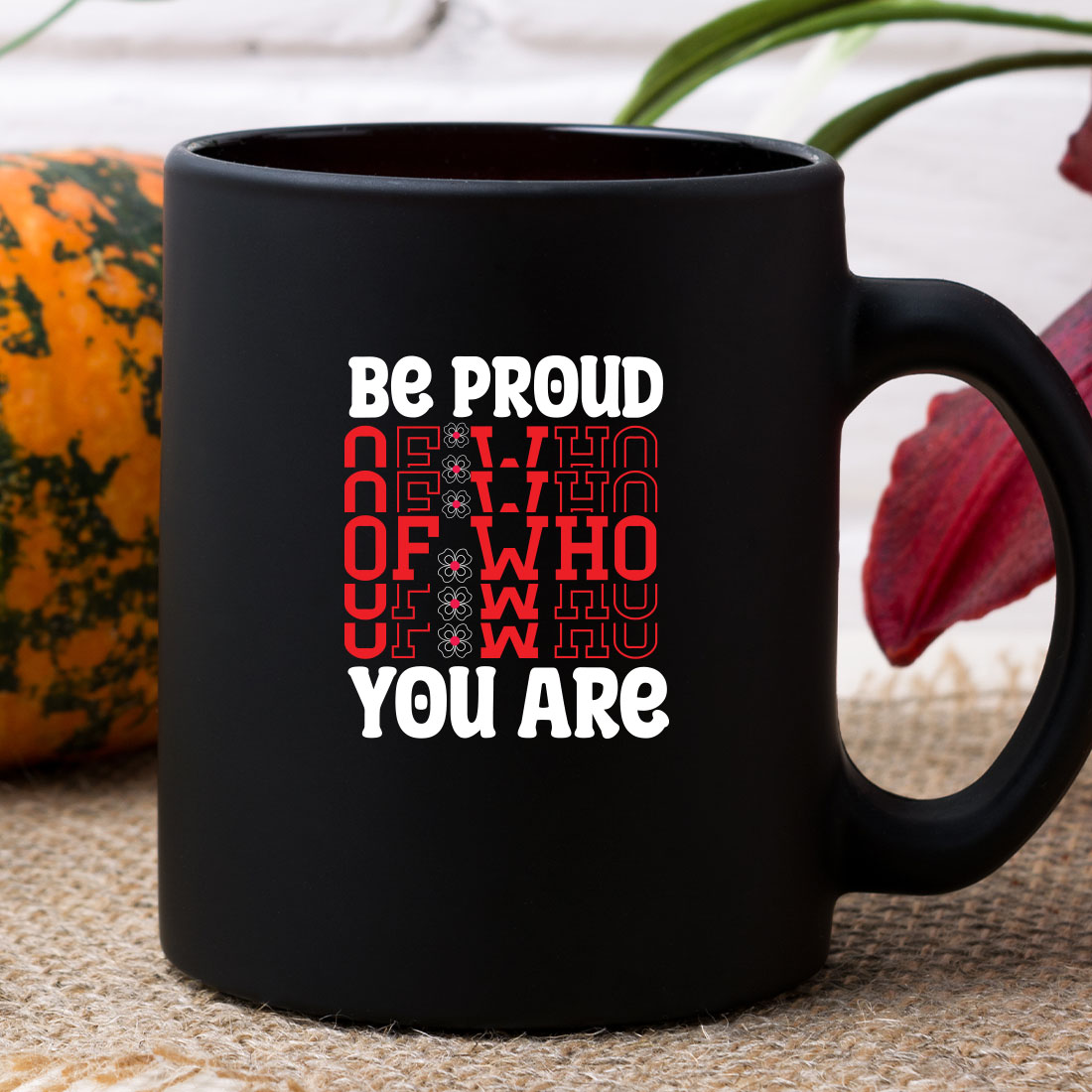 Black coffee mug sitting on top of a table.