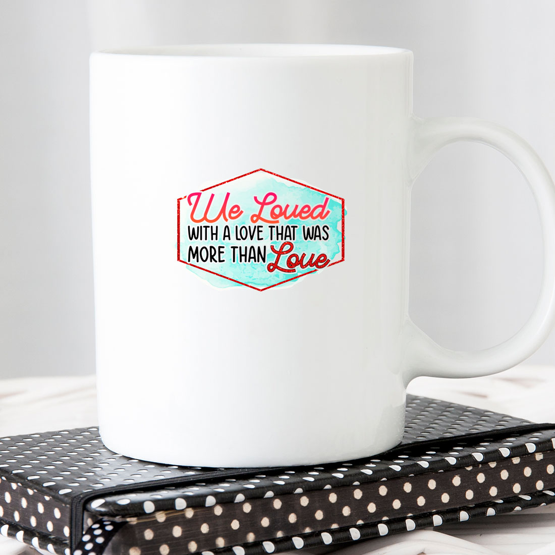 White coffee mug sitting on top of a book.