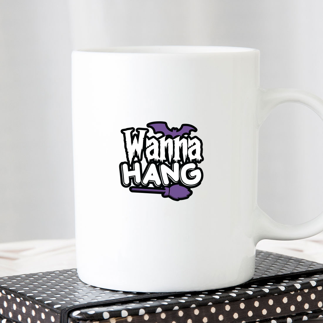 White coffee mug with the words wanna hang on it.