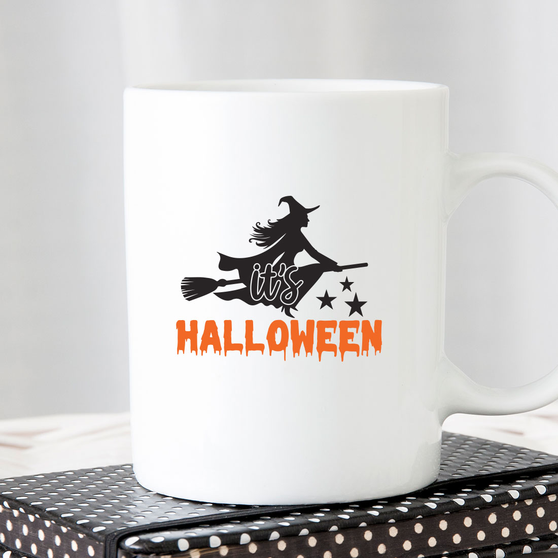 White coffee mug with a witch on it.