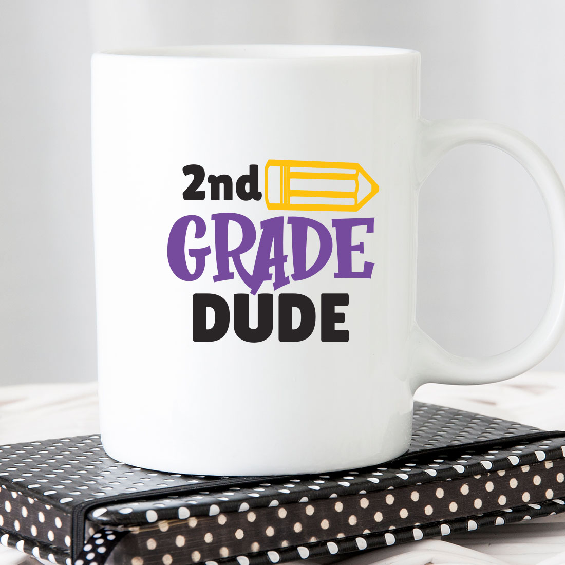 White coffee mug with the words 2nd grade dude on it.