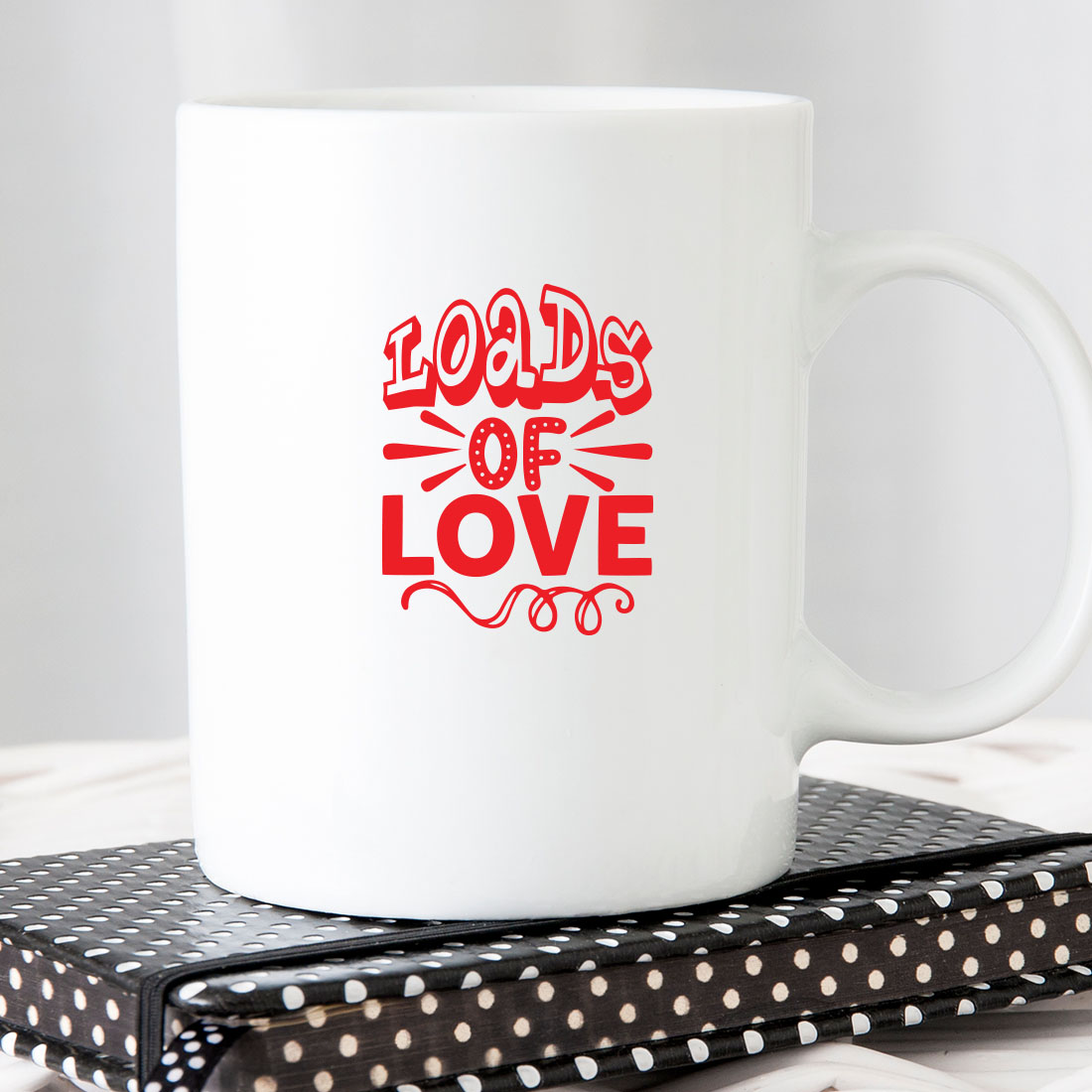 White coffee mug with the words loads of love on it.