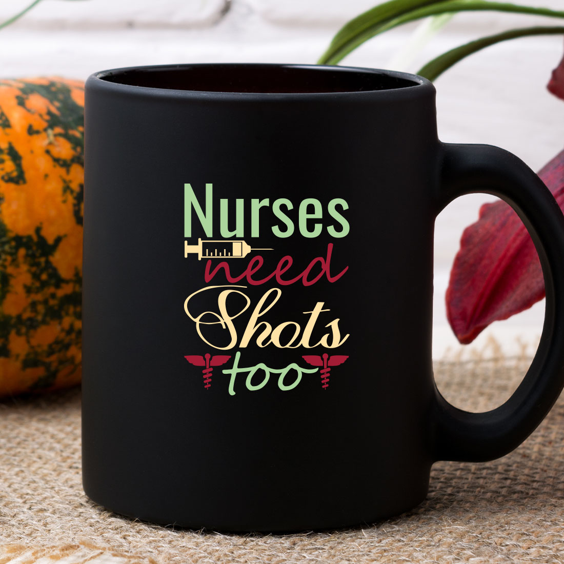 Black coffee mug that says nurses need shots too.