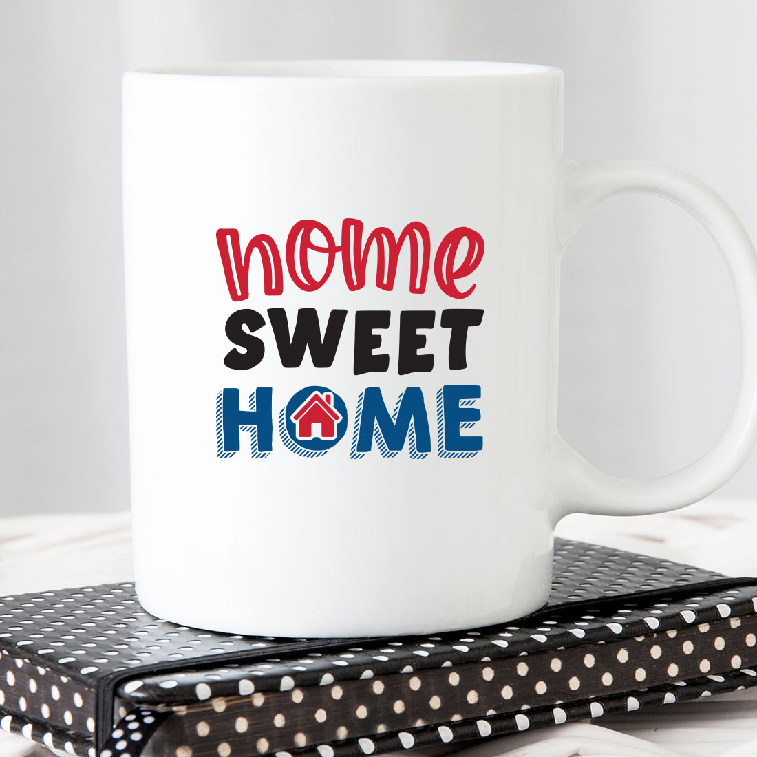 White coffee mug with the words home sweet home on it.