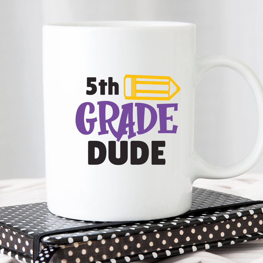 White coffee mug with the words 5th grade dude on it.