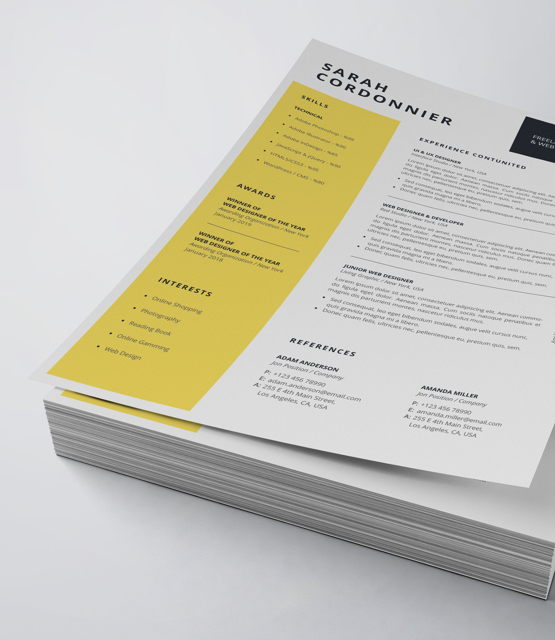 Yellow and black resume on top of a stack of papers.