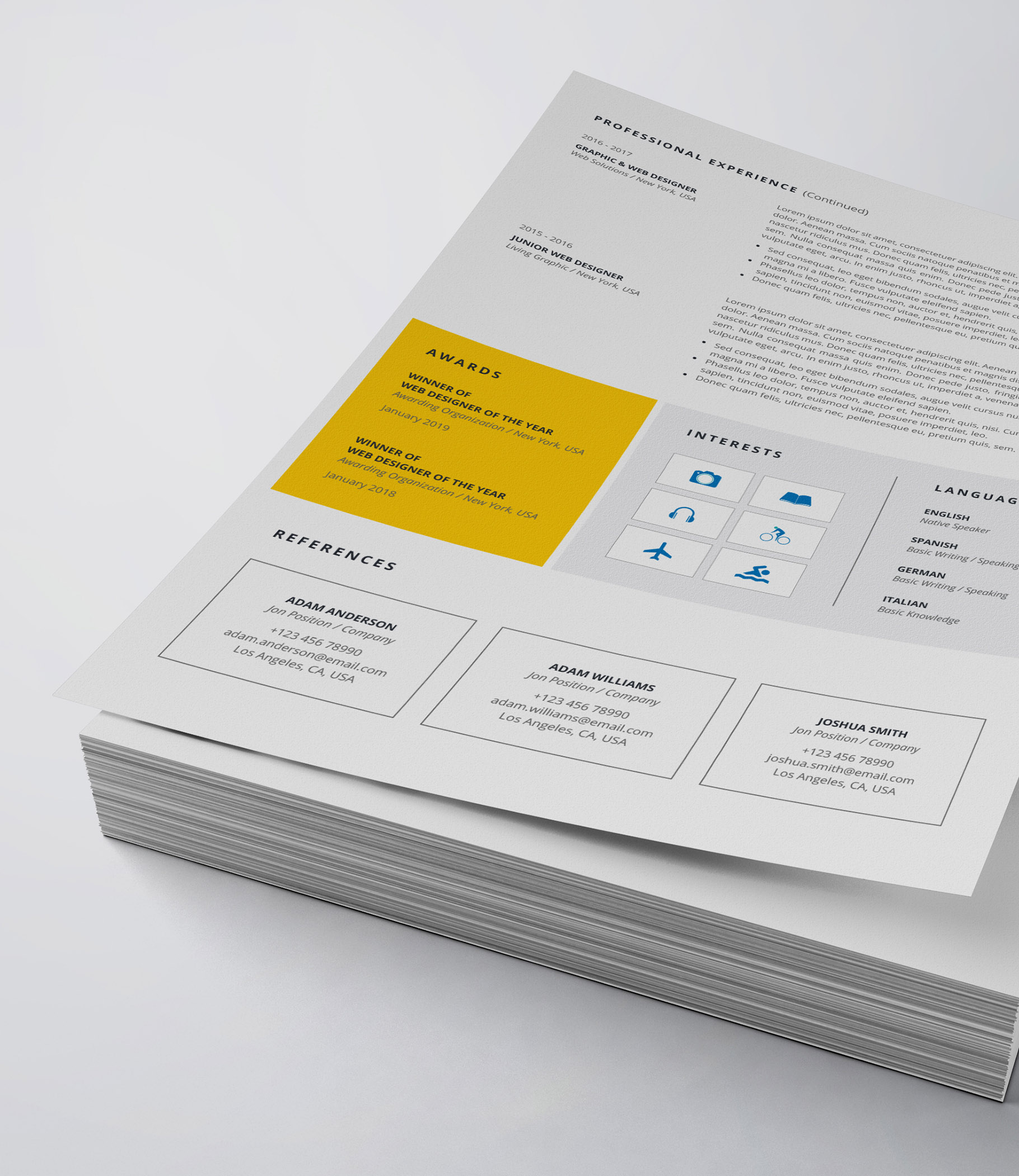 White and yellow resume on top of a stack of papers.