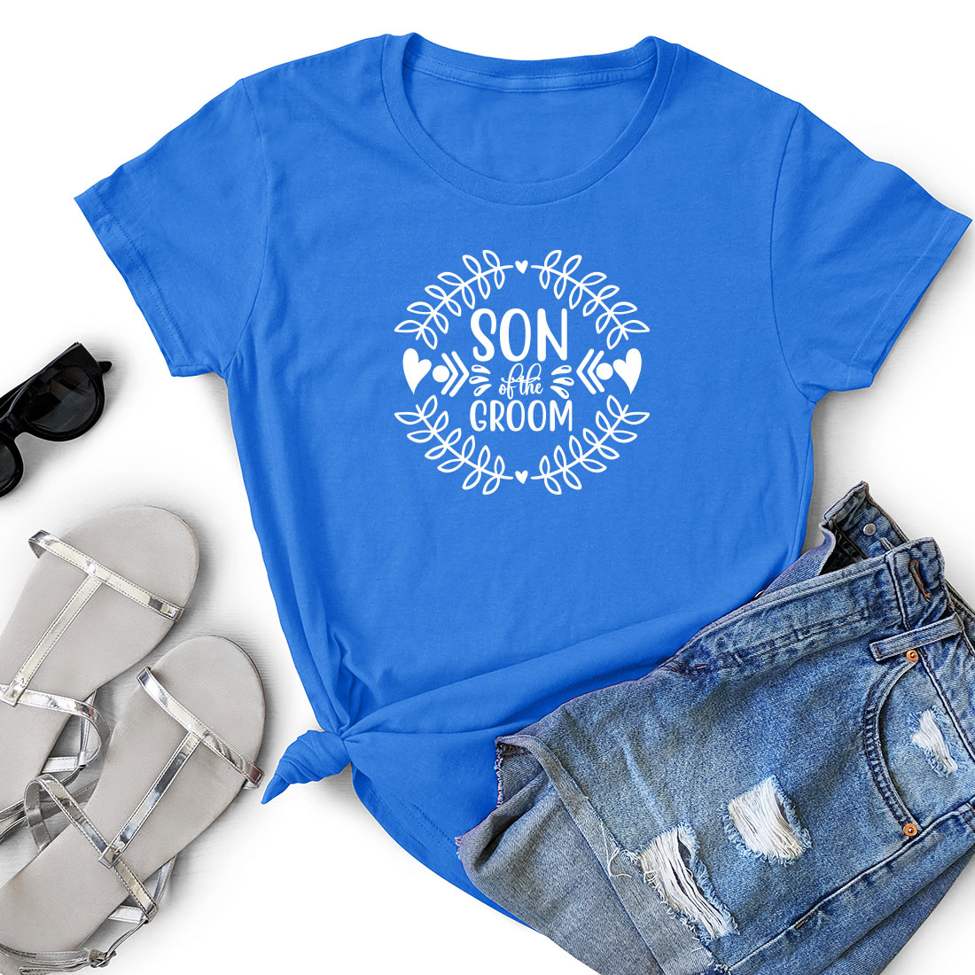 T - shirt that says son of the groom and a pair of shorts.