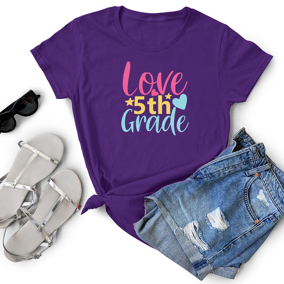 T - shirt that says love 5th grade next to a pair of shorts.