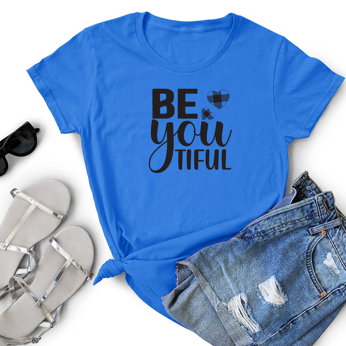 T - shirt that says be you tiful next to a pair of shorts.