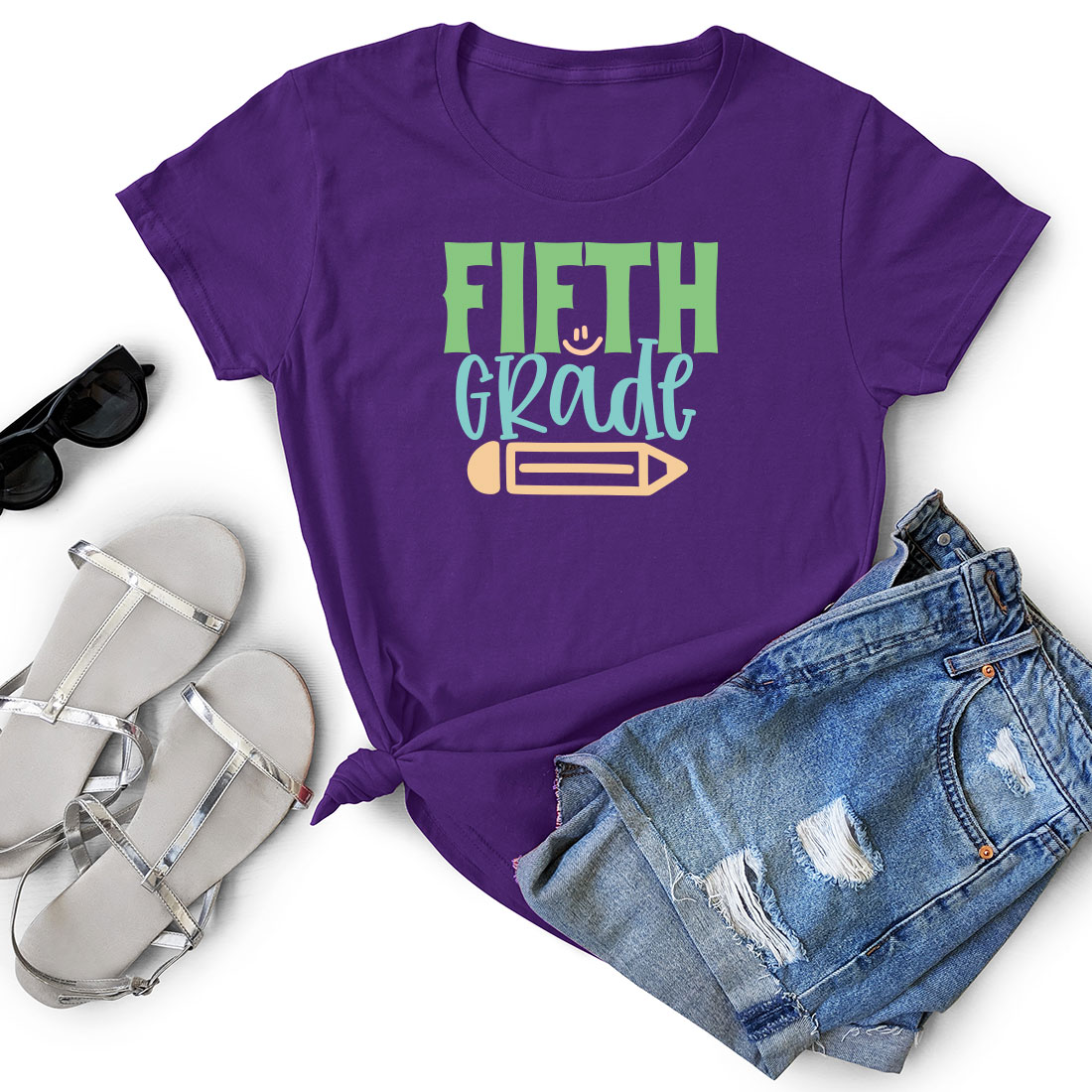 Purple shirt that says fifth grade next to a pair of shorts.