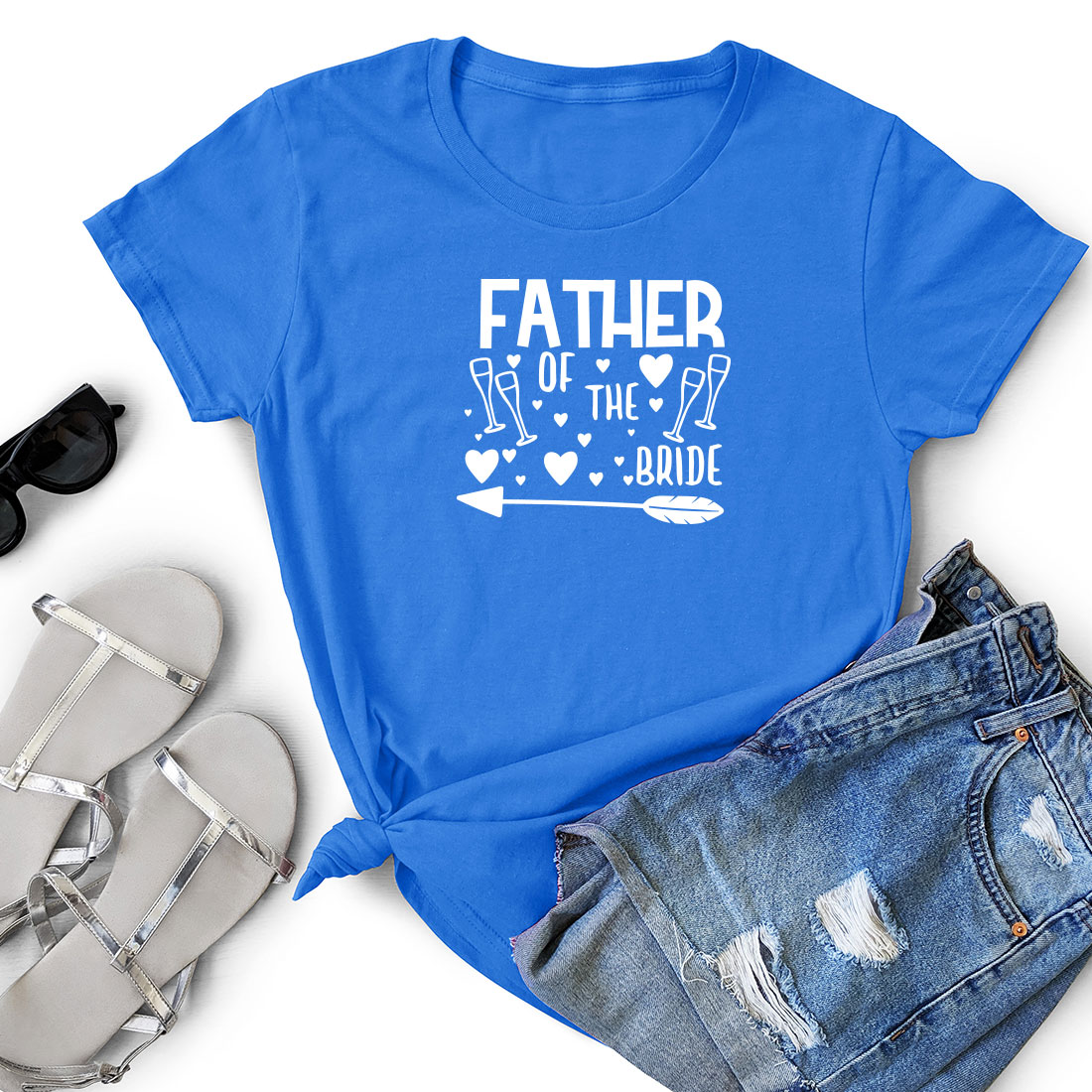 T - shirt that says father of the bride next to a pair of shorts.