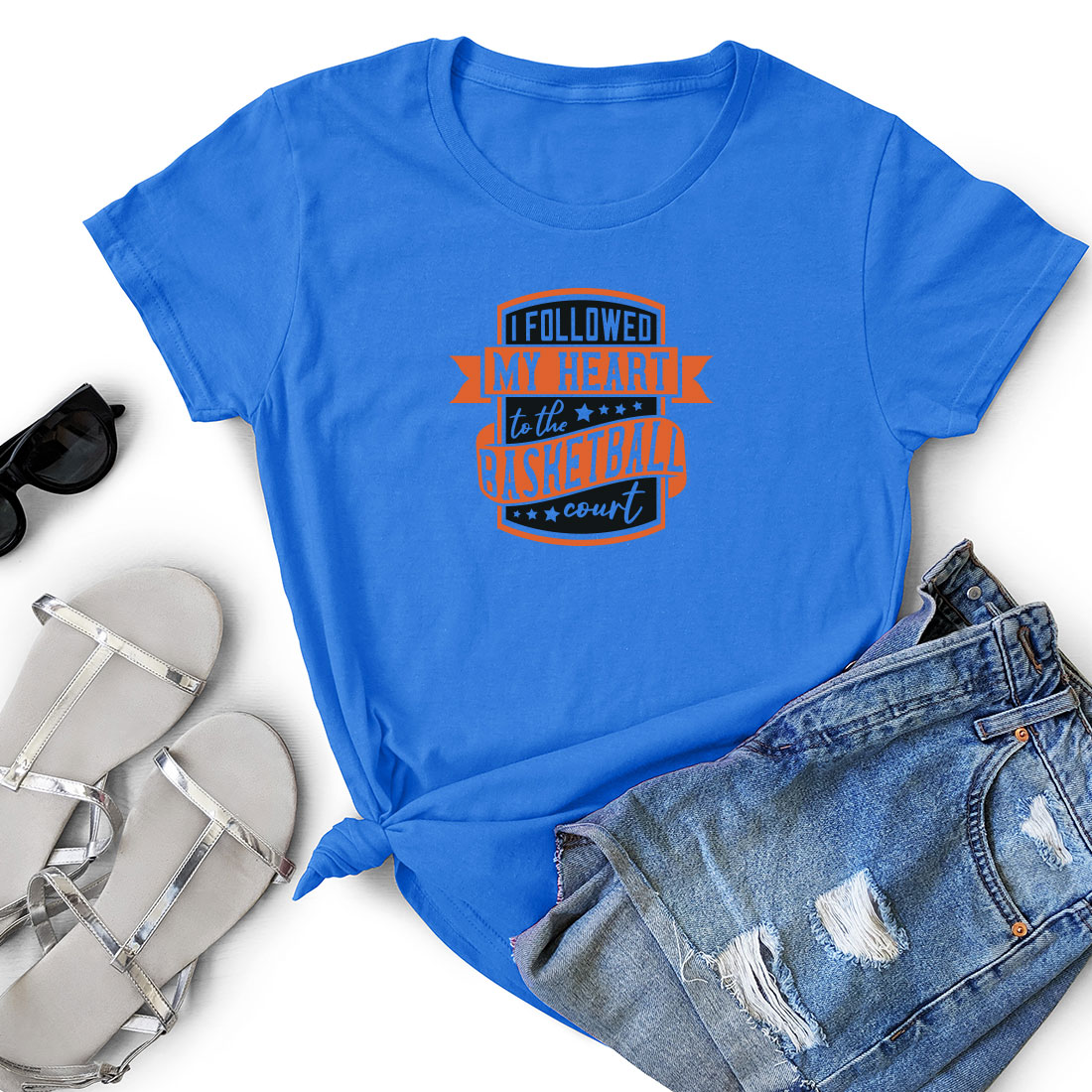Women's blue shirt with an orange and black graphic on it.