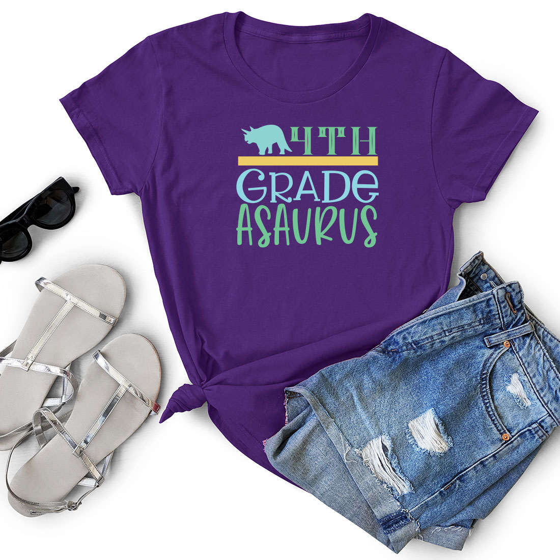 Purple shirt with the words fifth grade astouns next to a pair of.