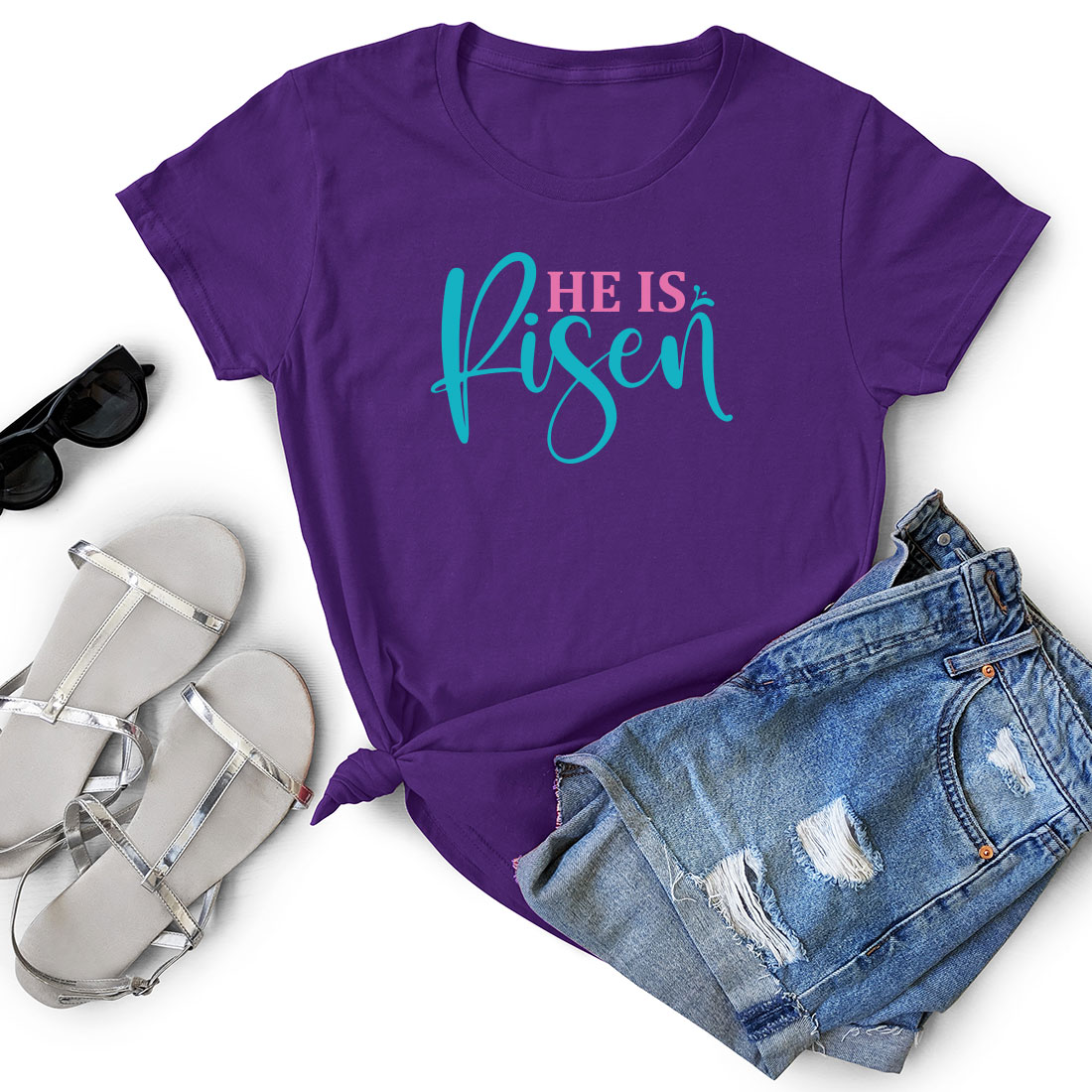 Purple shirt that says he is risen next to a pair of shorts.