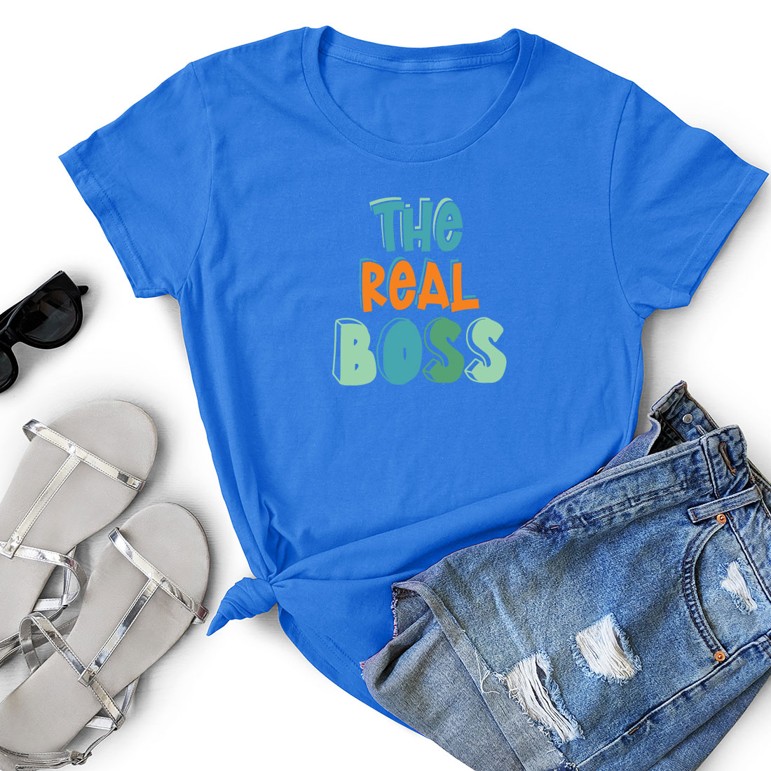 T - shirt that says the real boss next to a pair of shorts.