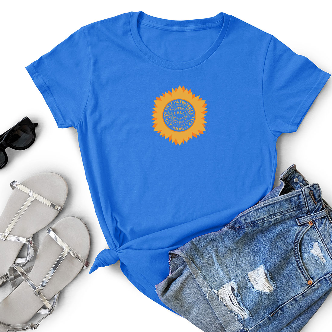 T - shirt with a sunflower on it next to a pair of shorts.