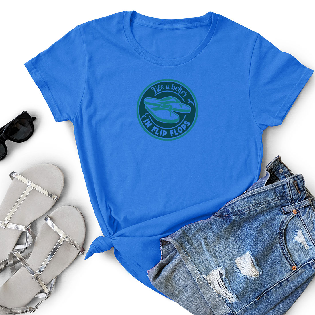Women's blue shirt with a green logo next to a pair of shorts.
