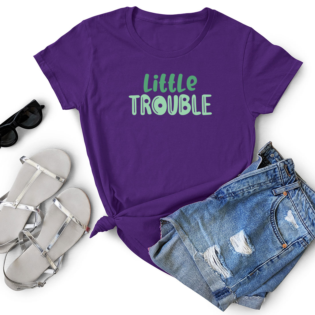 Purple shirt that says little trouble next to a pair of shorts.