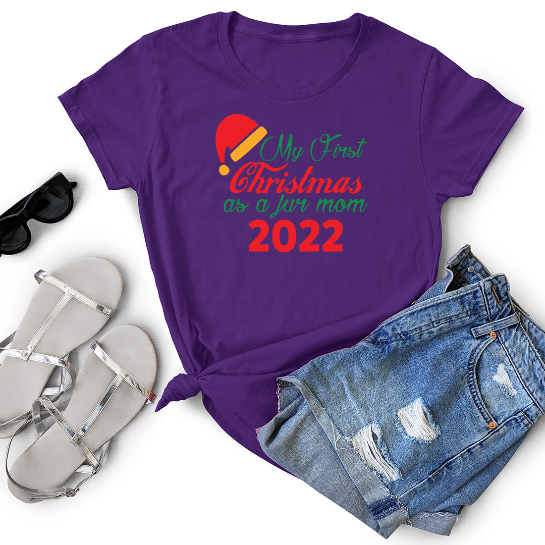 Purple t - shirt with the words my first christmas and a pair of shorts.